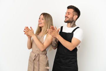 Restaurant waiter over isolated white background applauding after presentation in a conference