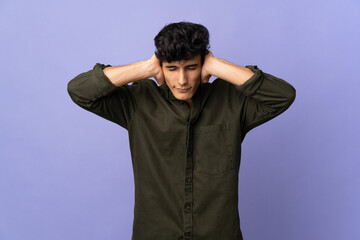 Young Argentinian man isolated on background frustrated and covering ears