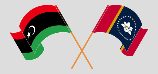 Crossed and waving flags of Libya and the State of Mississippi