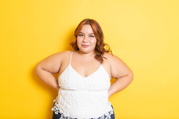 Plus size redhead young woman modeling with smile. overweight model