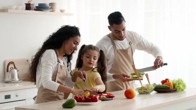 Happy Arab Family Cooking Together In Modern Kitchen