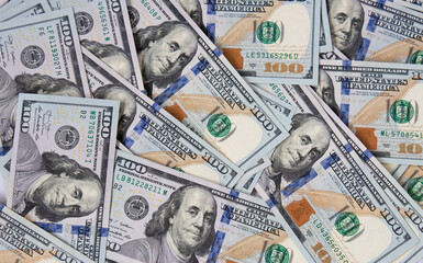 Background of hundred-dollar bills. The texture of hundred-dollar bills. A lot of dollars