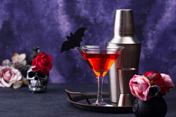 Halloween martini cocktail on purple background