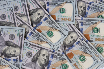 Background of hundred-dollar bills. The texture of hundred-dollar bills. A lot of dollars