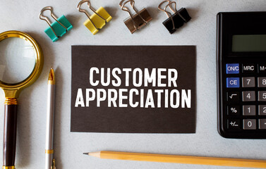 Customer Appreciation text written on a notebook with pencils
