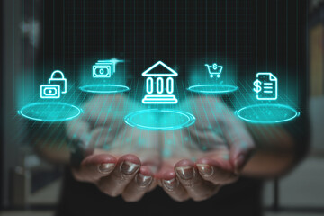 Online banking concept with futuristic design and graphics over hands. Financial icons as a projection of the image.