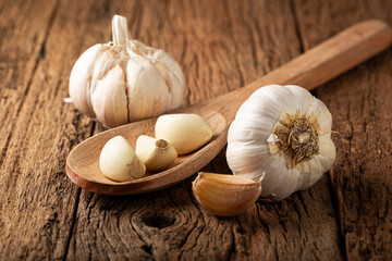 Garlic bulb and garlic cloves on the wooden table.