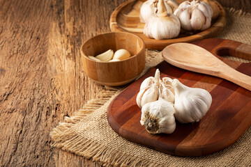 Garlic bulb and garlic cloves on the wooden table.