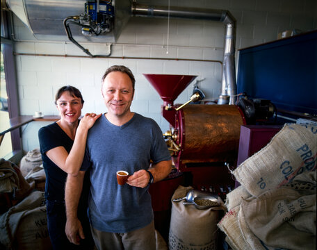 Portrait Of Coffee Master Roasters Sampling Cup Of Coffee In Roasting Room