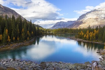 Fototapeta na wymiar Scenic Aerial View of Beautiful Linda Lake with Clouds and Mountains Reflected in Calm Water. Autumn Colors Hiking in Yoho National Park, British Columbia, Canadian Rockies