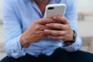 Unrecognizable man checking cell phone