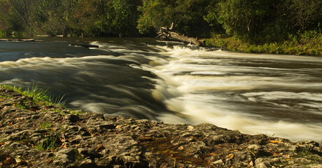Abava river waterfall near Sabile in autumn day, Latvia.