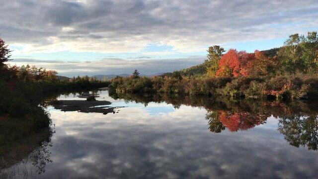Reflective Autumn Riverway & Distant Mountain Scene