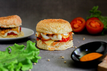 beef burger with tomato sauce and mayonnaise on a dark background
