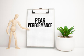 PEAK PERFORMANCE sign on small wood board rest on the easel with medical stethoscope