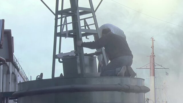 Men working with a Buoy in the Port of Buenos Aires, Argentina.  