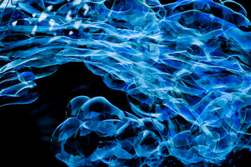 Obraz premium A cloud of bubbles that creates beautiful textures. Blue with black background