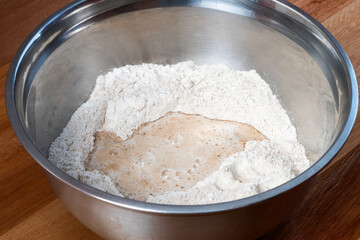 aluminum bowl with flour and fermenting yeast