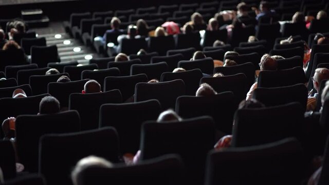 Audience in a movie theater watching a film - big cinema