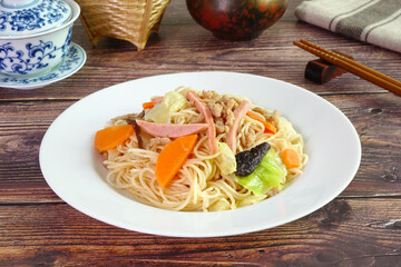 Vegetarian Hong Kong Noodle.  Stir fried Hong Kong noodle with mushroom, carrots, green vegetables and veggie sausage. Chinese vegetarian noodle for vegetarian festival.