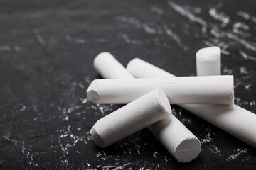 Pile of white chalk on black slate background