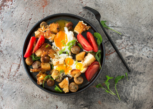 Flat Lay Plate Of Fried Eggs With Mushrooms And Tomatoes On The Table