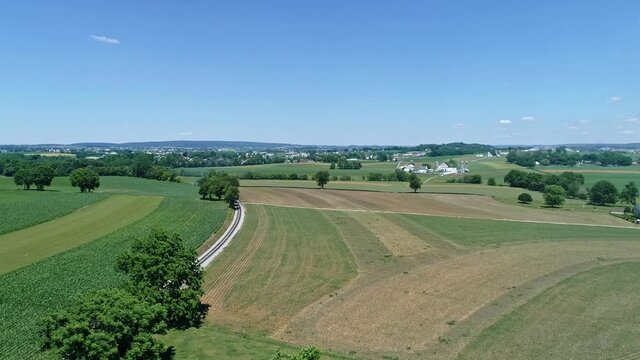 An Aerial View of Thomas the Tank Engine Approaching in the Distance by It's Self Rounding a Curve in the Track on a Beautiful Day