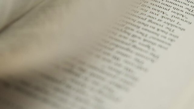 Slow motion of flicking through old book pages.