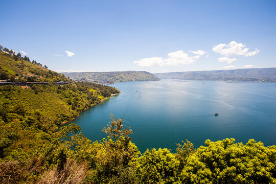 Lake Toba is a large natural lake in North Sumatra, Indonesia, located in the caldera of Mount Supervolcano. View from Parapat. This lake has a length of 100 kilometers, a width of 30 kilometers. 