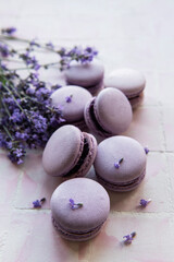 Fototapeta na wymiar French macarons with lavender flavor and fresh lavender flowers