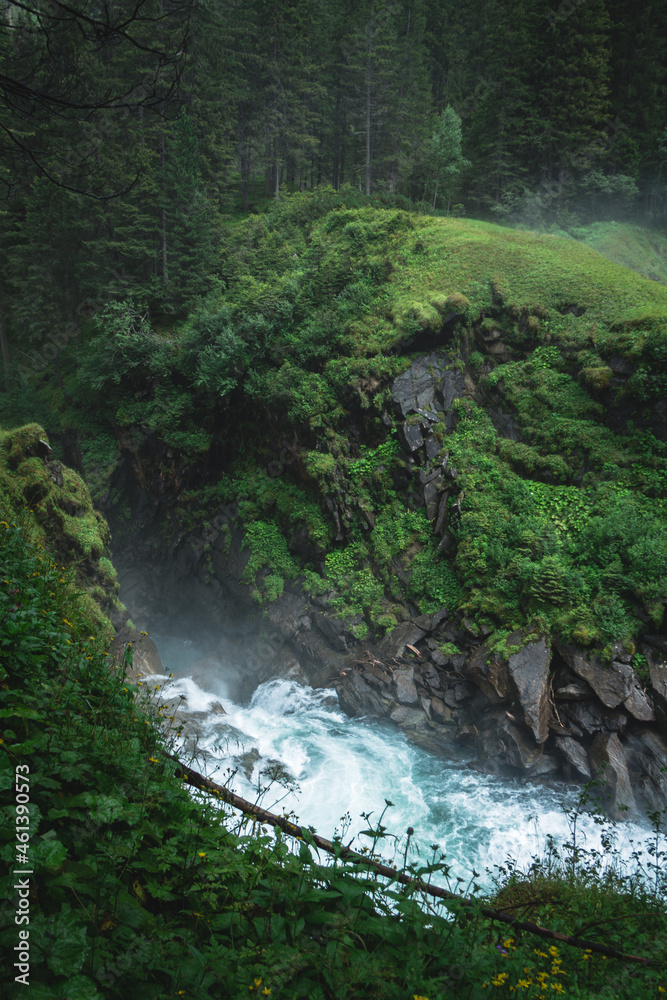 Sticker river flowing trough the forest.