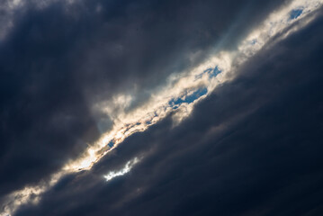 Obraz premium Rays of light shining throug dark clouds.Beautiful dramatic sky with sun rays.