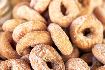 Group of sweet doughnuts in a stall of a store for sale on the street. Food concept