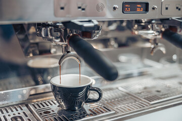 Professional coffee machine brewing coffee in cafeteria