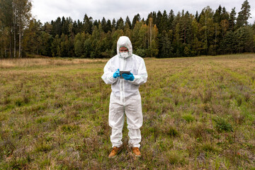 person in Hazmat Suit analyzing a contaminated field
