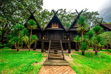 Fototapeta na wymiar Background of tourist attractions in Chiang Rai of Thailand, Baan Dam or Baan Dam Museum is an art museum. will be a group of wooden houses Lanna Art Strange shaped cement house, Thai style house The 