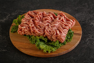 Raw pork minced meat over board