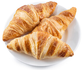 Tasty crusty croissants on the plate on white background. Top view. File contains clipping path.