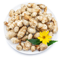 Jerusalem artichoke roots with leaves and flower of Jerusalem artichoke isolated on white background.