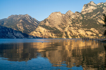 Fototapeta premium Sunrise at the north side of lake garda, with view of the mountains. From torbole