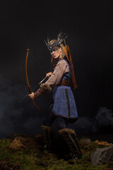 Beautiful female viking woman warrior in battle with bow. Ancient times. Amazon fantasy girl