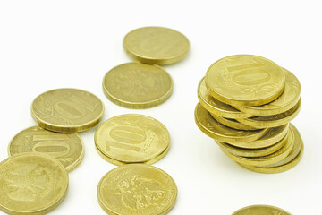 Tower of coins on a white background. The concept of money, investment, stock market. Selective focus.