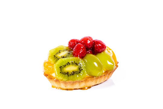 Freshly baked delicious tartlet with fruits isolated on a white background