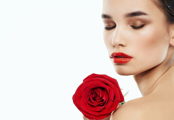Fototapeta na wymiar pretty woman bright makeup rose in hand clean skin posing