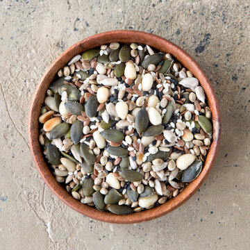 Flat Lay Of Wooden Bowl With Seed Mixture On Beige Table