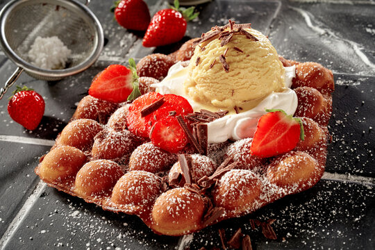 Gourmet bubble waffle summer dessert with fresh strawberries