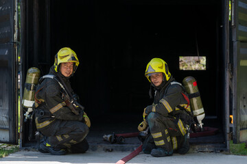 Fototapeta premium Firefighter portrait on duty,Firefighters in fire fighting operation.