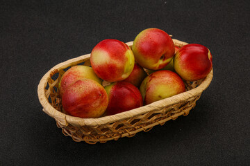 Sweet small nectarines in the basket