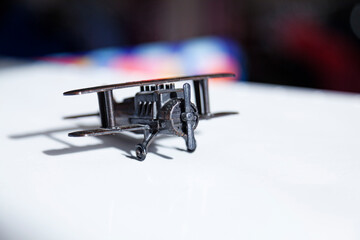 toy plane in metal on white surface
