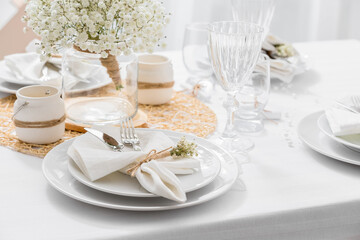 Beautiful table setting with gypsophila flowers in restaurant